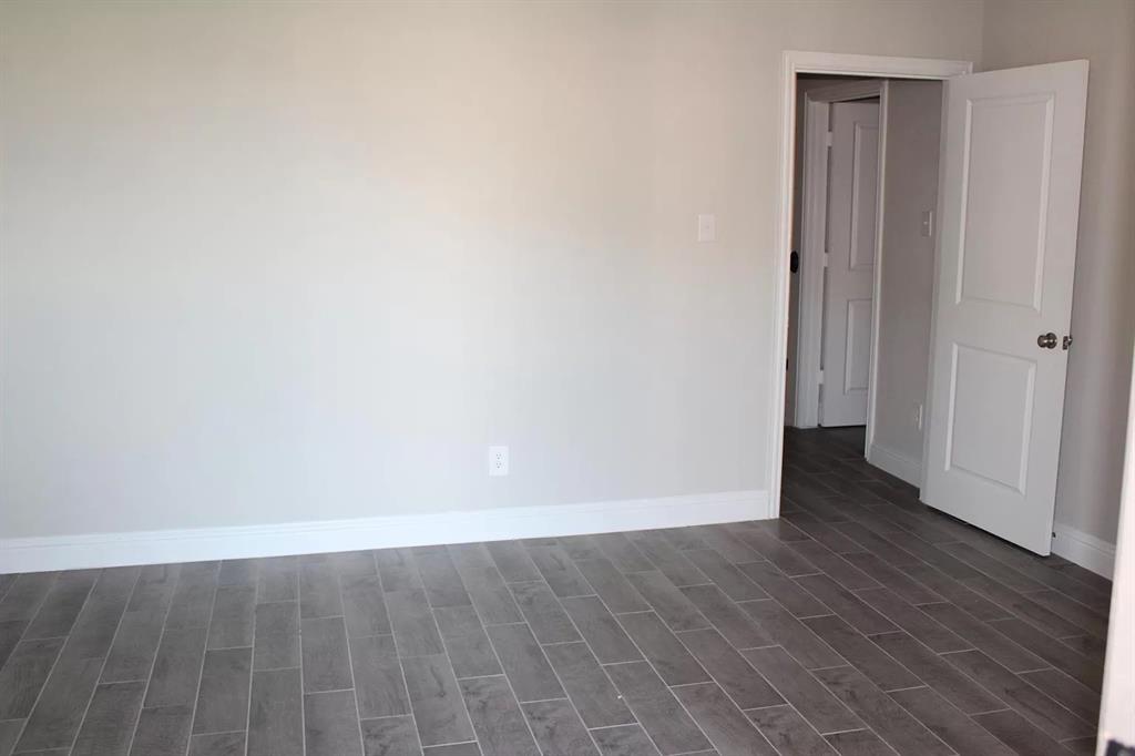 1752 Redding Street Allen, TX 75002 - Photo 12 of 24 Unfurnished room with dark hardwood / wood-style flooring
