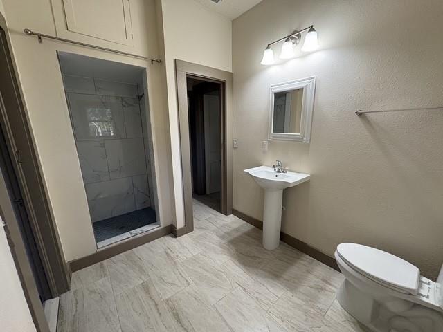 4876 East Williams Spring Road Fort Worth, TX 76135 - Photo 10 of 20 a bathroom with a sink a toilet and mirror
