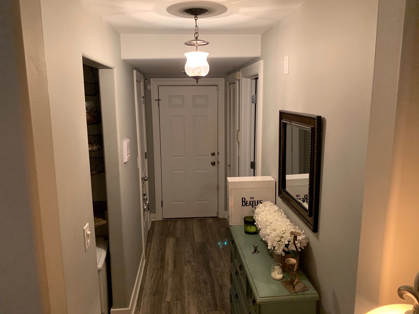 4335 West Irving Park Road, Unit 106 Chicago, IL 60641 - Photo 2 of 12 a view of a hallway with wooden floor and a livingroom