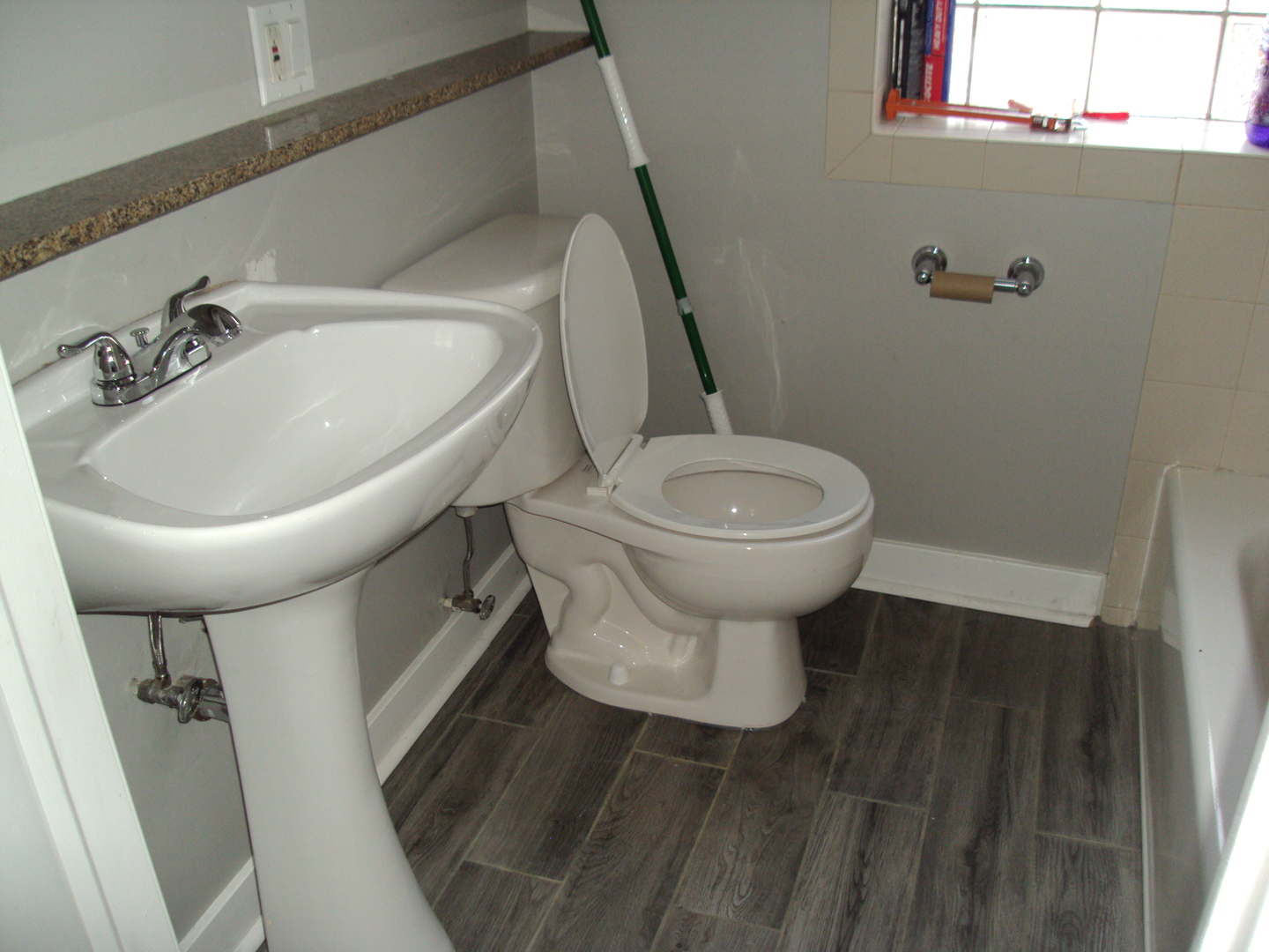 4335 West Irving Park Road, Unit 106 Chicago, IL 60641 - Photo 11 of 12 a bathroom with a toilet sink and mirror