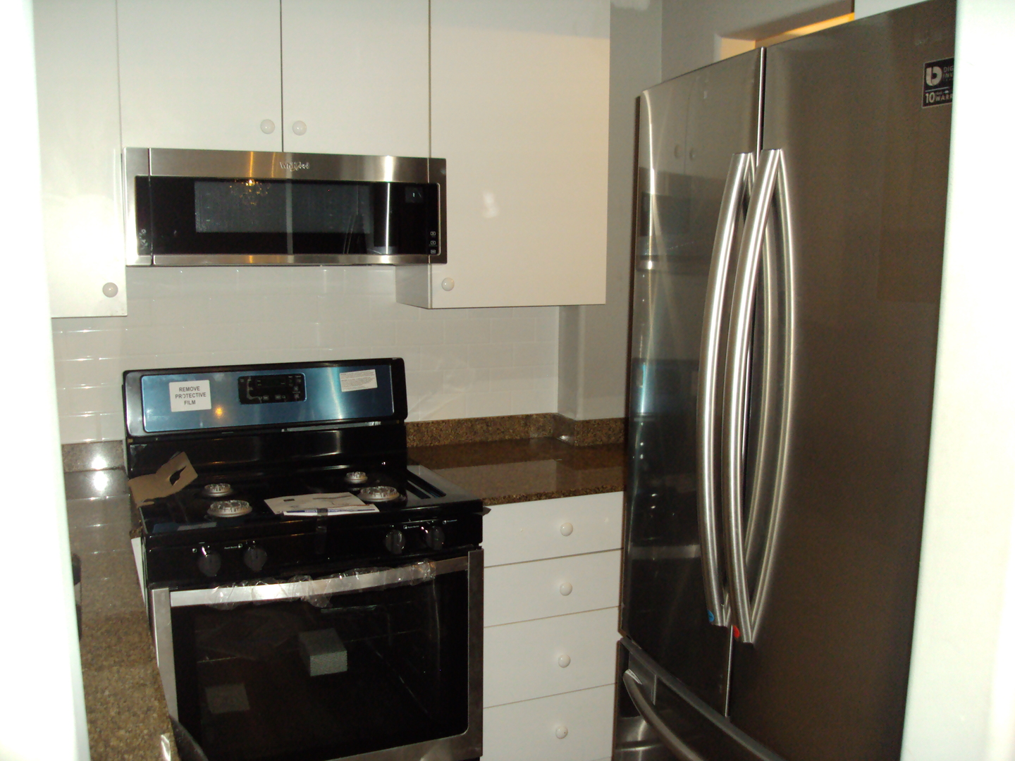 4335 West Irving Park Road, Unit 106 Chicago, IL 60641 - Photo 7 of 12 a kitchen with a stove and a refrigerator