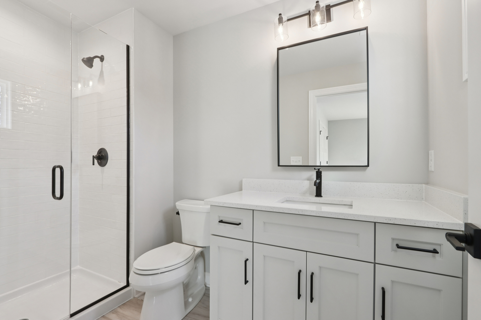 39-w910 Catlin Square Geneva, IL 60134 - Photo 14 of 18 a bathroom with a toilet sink vanity and mirror