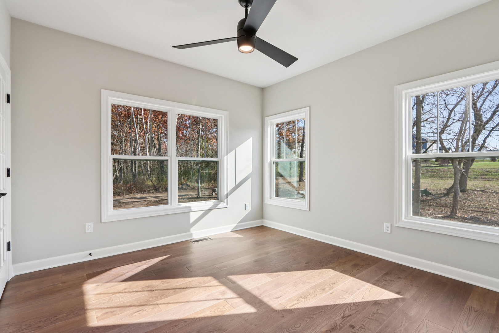 39-w910 Catlin Square Geneva, IL 60134 - Photo 7 of 18 a view of an empty room with a window and wooden floor