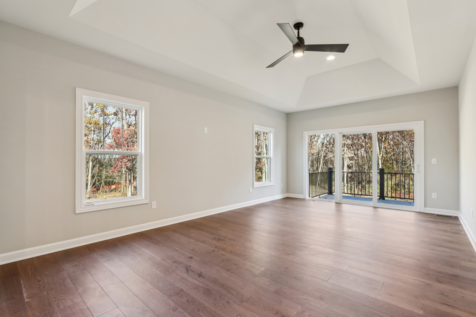39-w910 Catlin Square Geneva, IL 60134 - Photo 10 of 18 a view of an empty room with a window and wooden floor