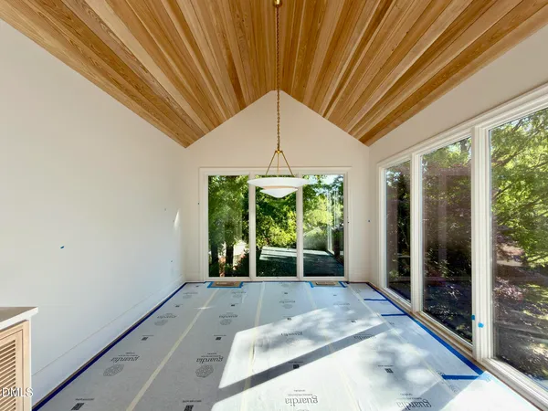 a kitchen with white cabinets and window