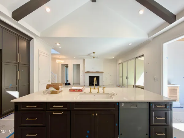 a kitchen that has a sink and a stove in it