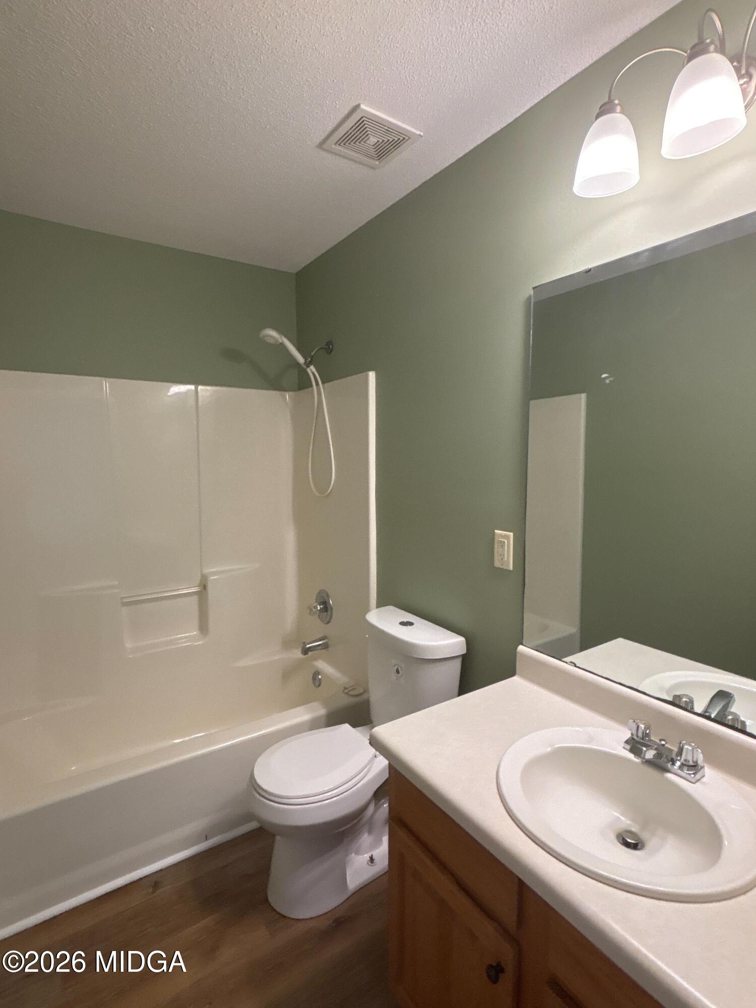 404 Dunmurry Place Warner Robins, GA 31093 - Photo 13 of 18 a bathroom with a sink toilet and shower