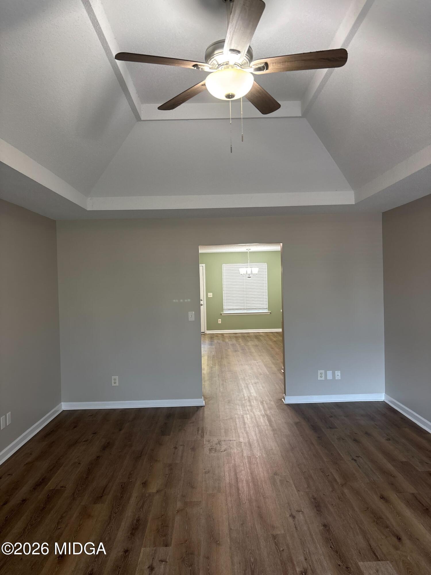 404 Dunmurry Place Warner Robins, GA 31093 - Photo 8 of 18 a view of an empty room with wooden floor and a ceiling fan