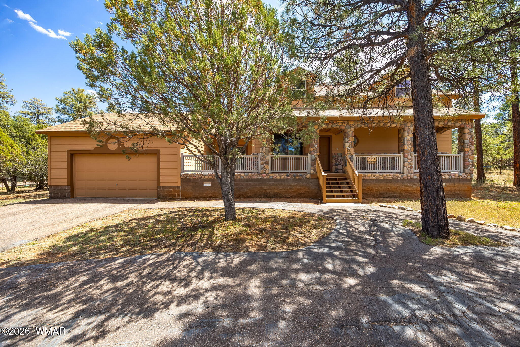 2937 Ransack Road Overgaard, AZ 85933 - Photo 2 of 34 a tree is standing in front of a house