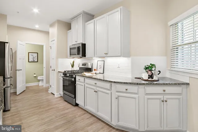 a bathroom with a sink mirror and toilet