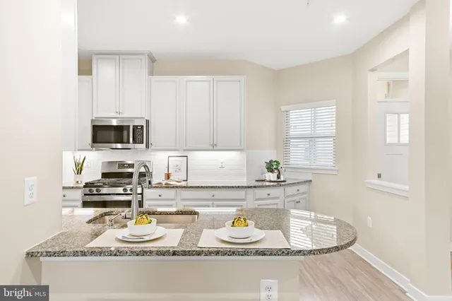 a kitchen with sink stove and microwave