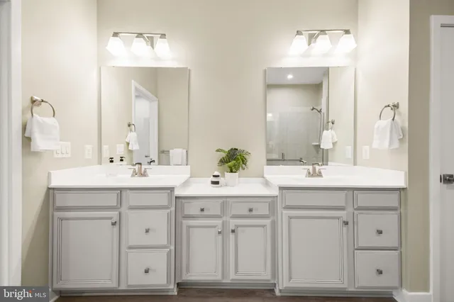 a bathroom with a sink vanity and mirror