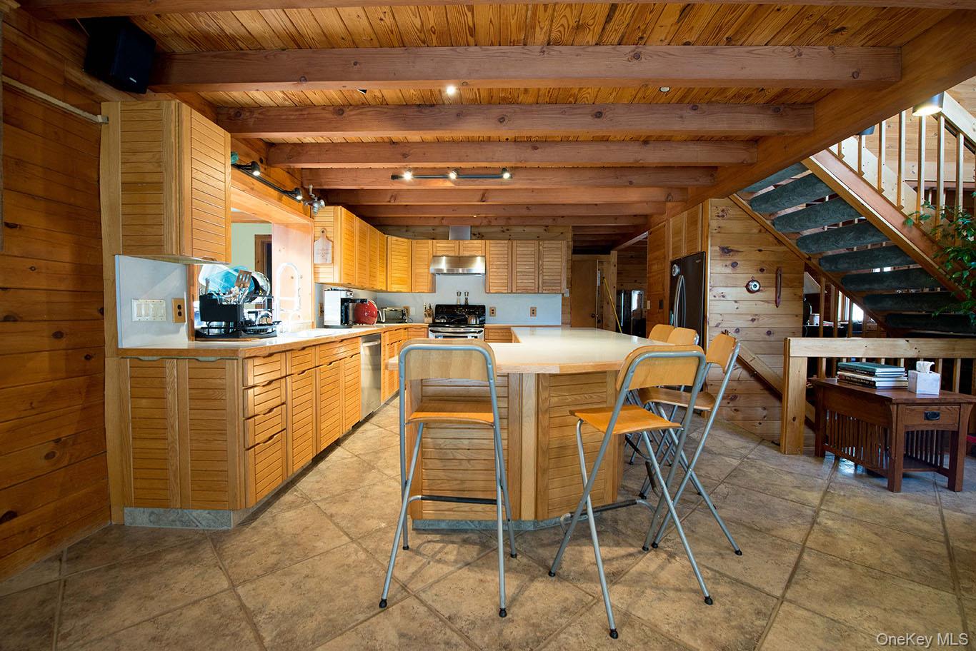 1644 Lakes Road Monroe, NY 10950 - Photo 12 of 49 a dining room with furniture and a kitchen view