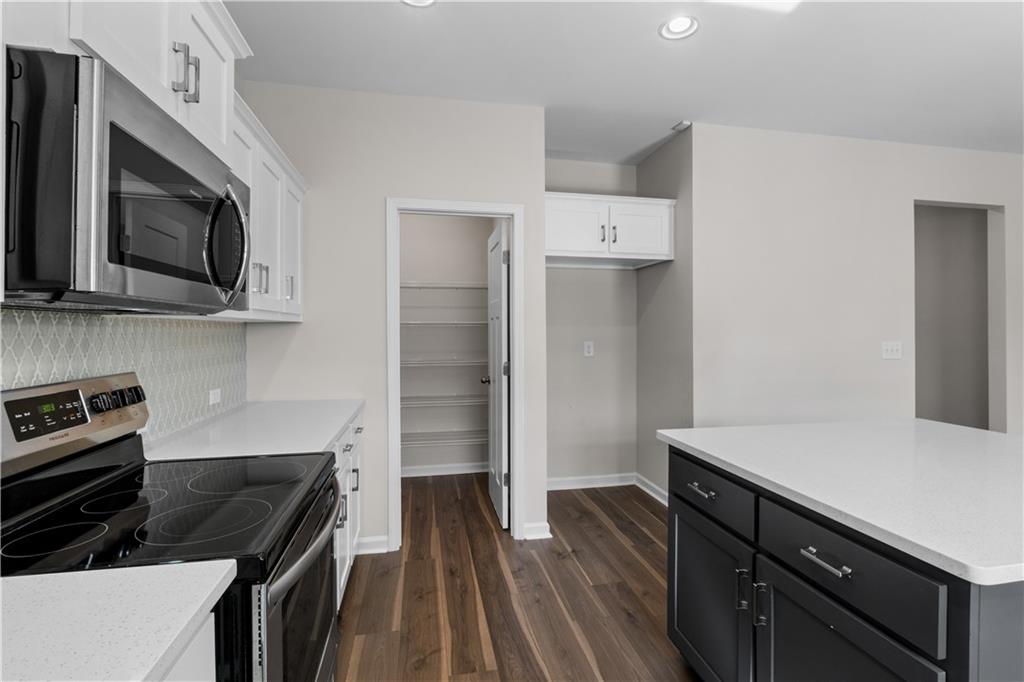 150 Cedar Pk Way Carrollton, GA 30117 - Photo 13 of 37 a kitchen with kitchen island granite countertop stainless steel appliances and wooden cabinets