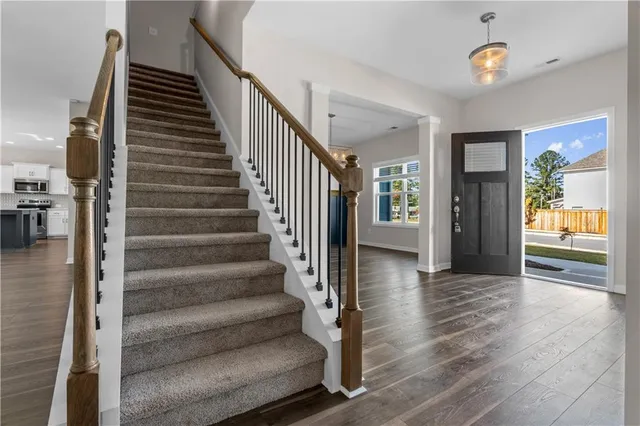 a view of a hallway with windows and stairs
