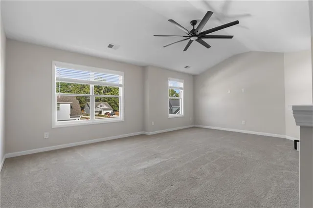 a view of a livingroom with a ceiling fan and window