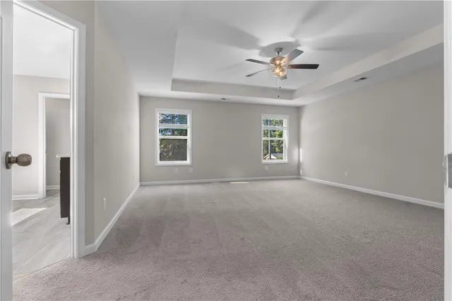 a view of a livingroom with a ceiling fan and window