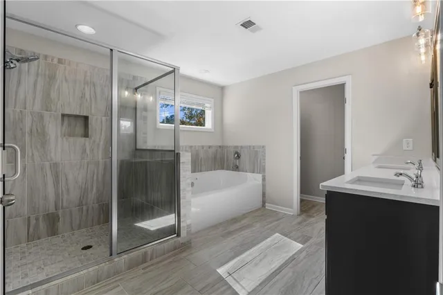 a bathroom with a bathtub a sink and a mirror