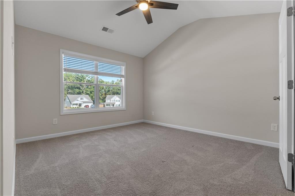 150 Cedar Pk Way Carrollton, GA 30117 - Photo 25 of 37 an empty room with a window and a ceiling fan