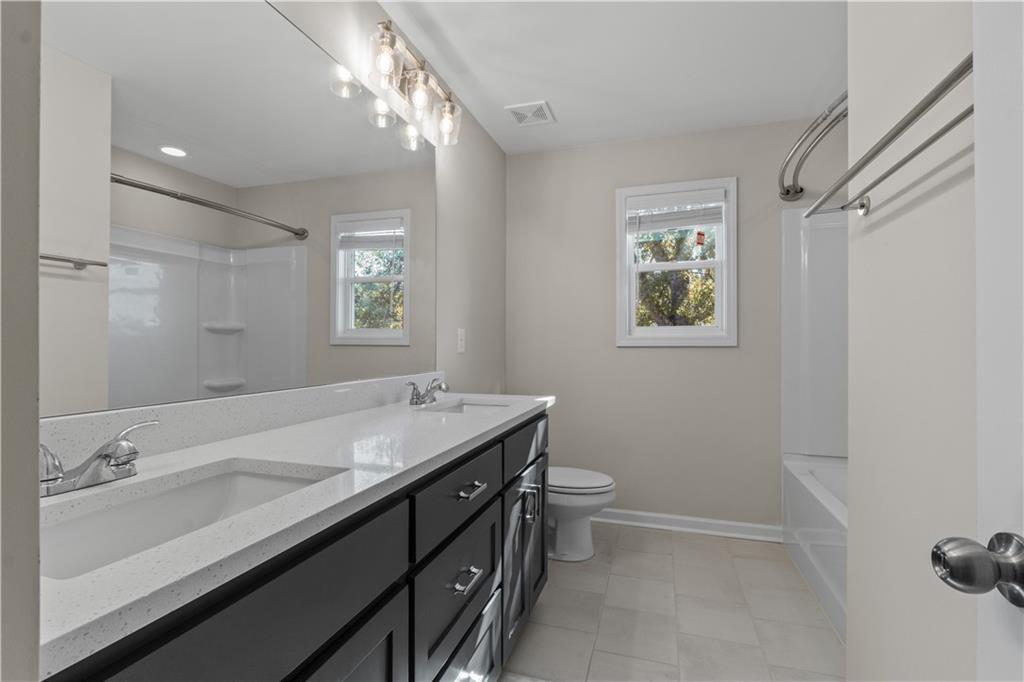 150 Cedar Pk Way Carrollton, GA 30117 - Photo 28 of 37 a bathroom with a sink a toilet and a mirror