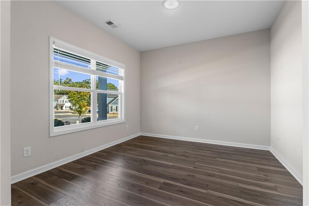 150 Cedar Pk Way Carrollton, GA 30117 - Photo 7 of 37 a view of an empty room with wooden floor and a window