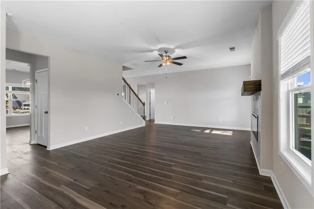 a kitchen with white cabinets stainless steel appliances and a window