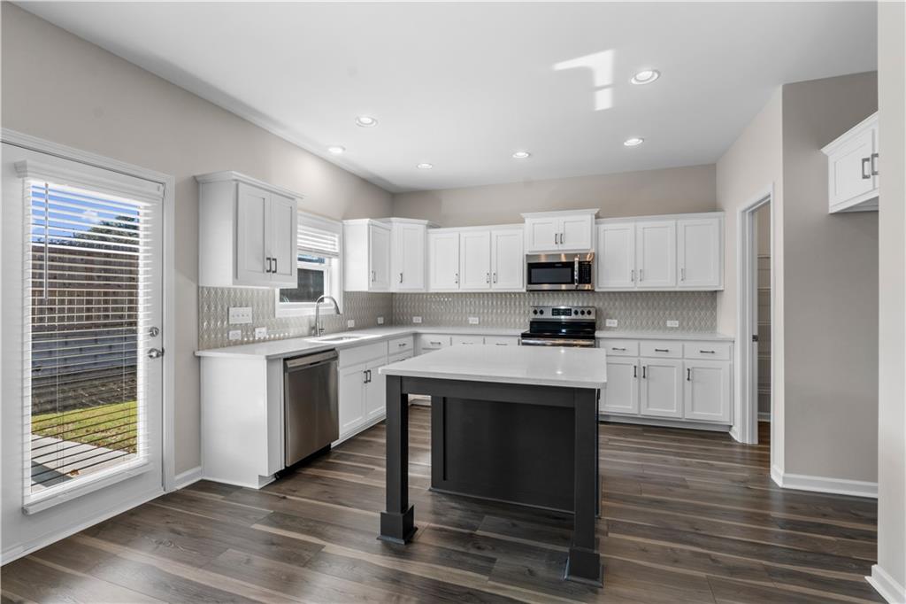 150 Cedar Pk Way Carrollton, GA 30117 - Photo 10 of 37 a kitchen with white cabinets stainless steel appliances and a window