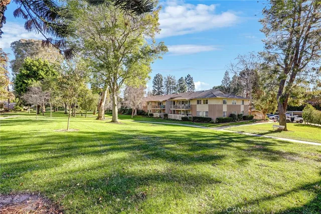 a aerial view of a house with a big yard and large trees
