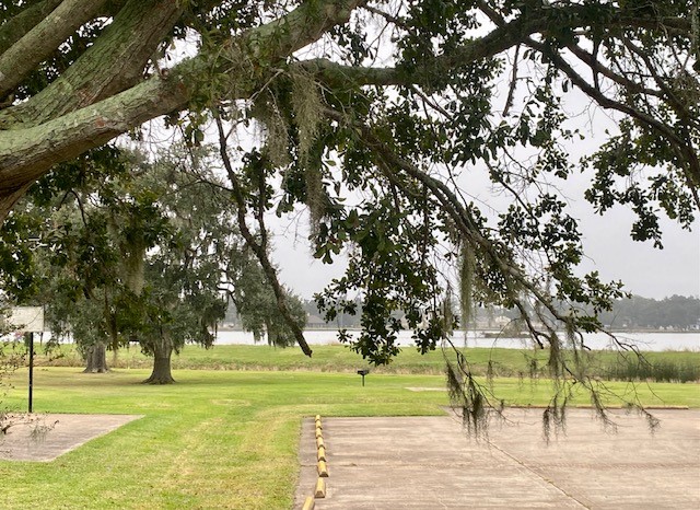 218 Cattle Drive Trail Angleton, TX 77515 - Photo 10 of 34 Here is a view of the lake near the primary facility with the tennis courts, playground, and pool nearby.