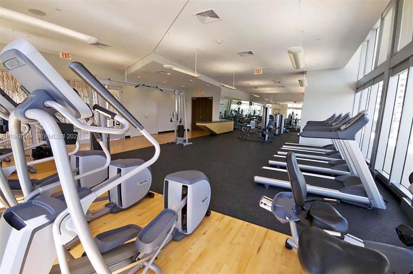 79 Southwest 12th Street, Unit 3008S Miami, FL 33130 - Photo 6 of 11 a room with lots of gym equipment and stairs