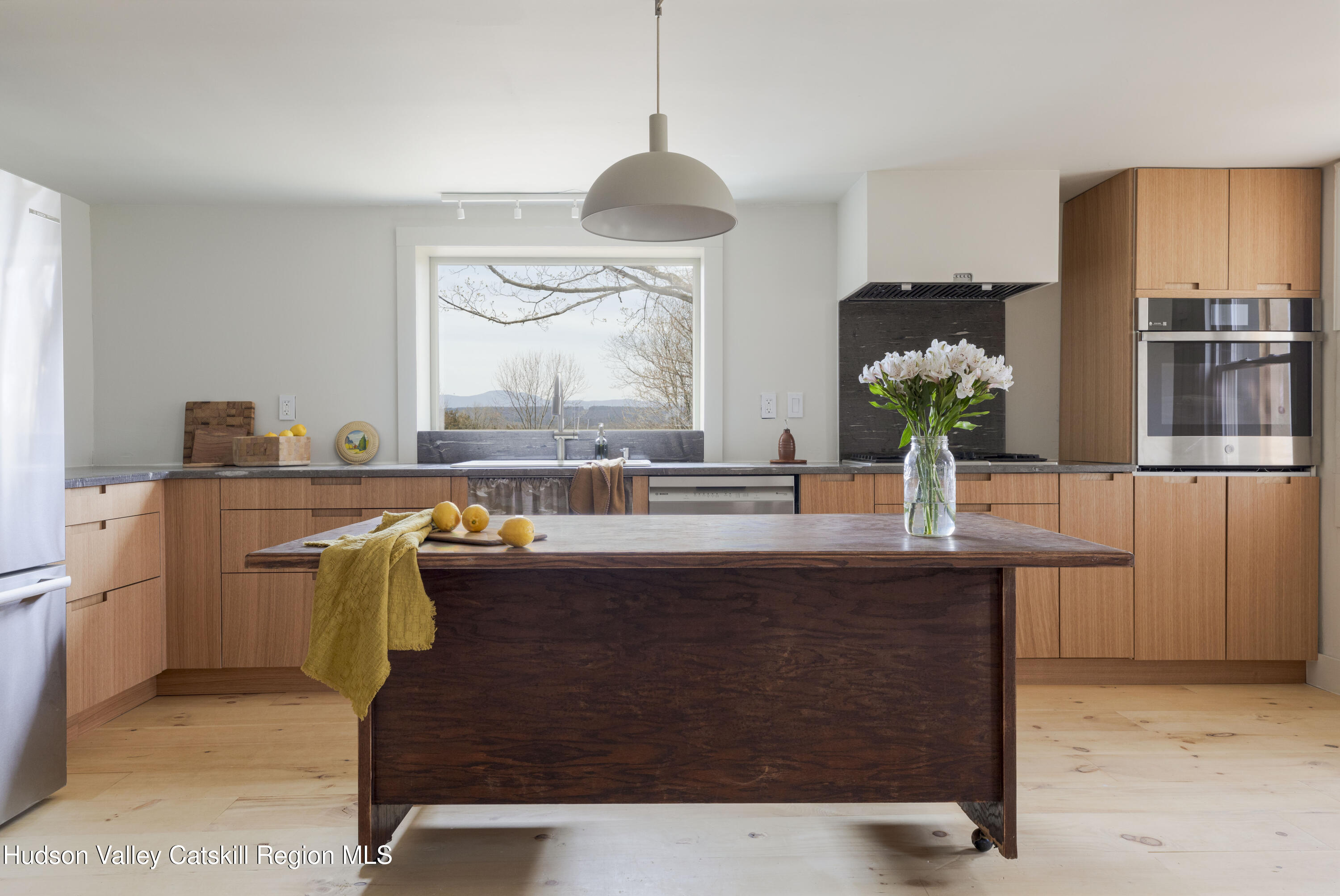 857 Flats Road Athens, NY 12015 - Photo 3 of 30 a room with kitchen island a table and chairs in it