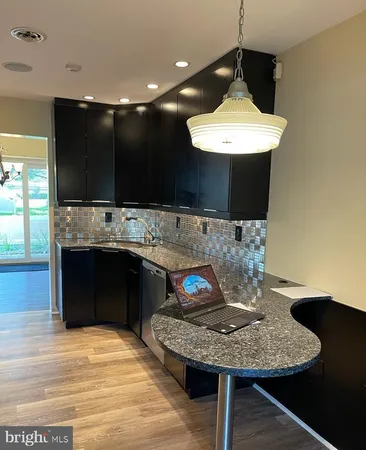 a kitchen with a table and a refrigerator