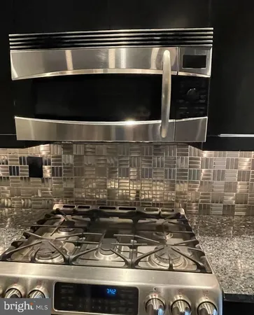 a stove top oven sitting inside of a kitchen