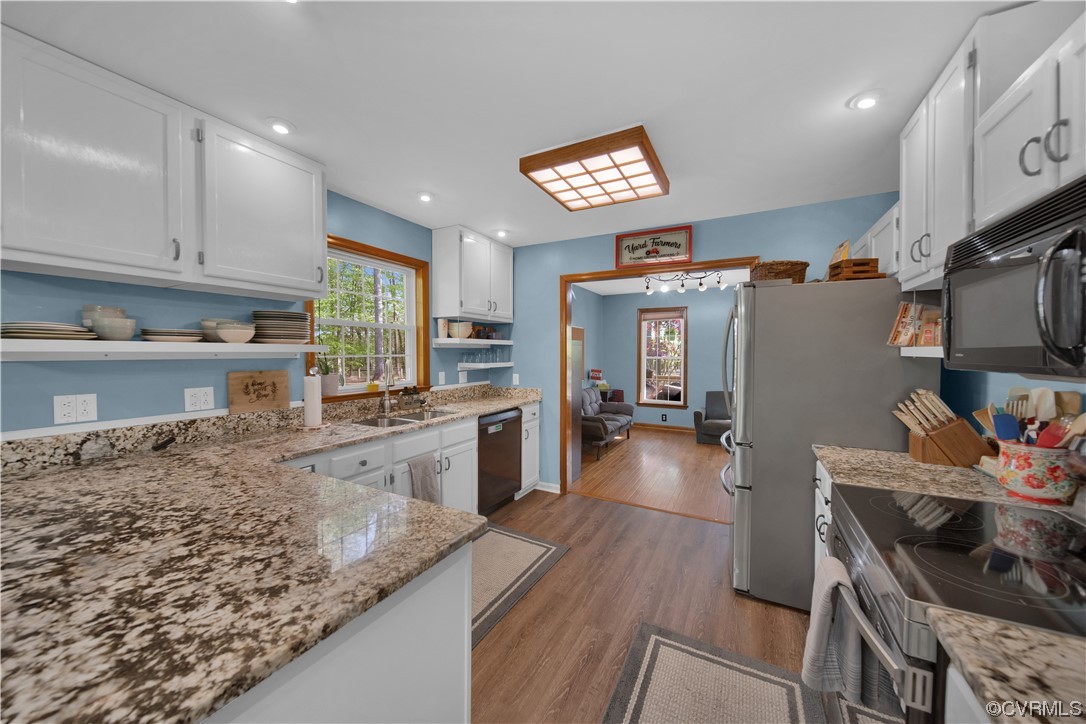 16116 Tyler Station Road Beaverdam, VA 23015 - Photo 13 of 50 a kitchen with stainless steel appliances granite countertop a sink stove and cabinets