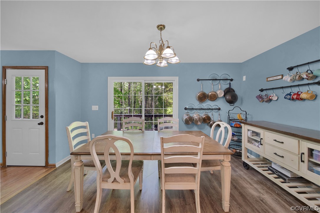 16116 Tyler Station Road Beaverdam, VA 23015 - Photo 14 of 50 a view of a dining room with furniture a chandelier and wooden floor