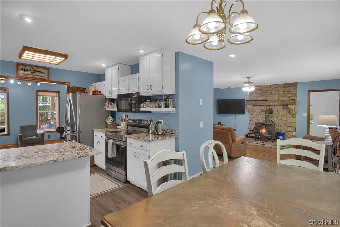 16116 Tyler Station Road Beaverdam, VA 23015 - Photo 16 of 50 a view of a kitchen with kitchen island stainless steel appliances refrigerator stove top oven and cabinets
