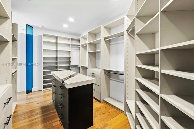 a view of a hallway with wooden floor and stairs