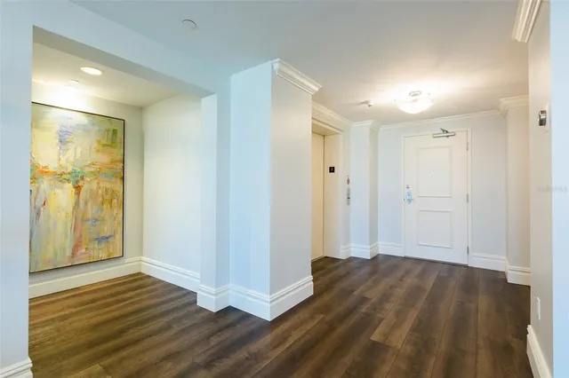 a view of a hallway with wooden floor