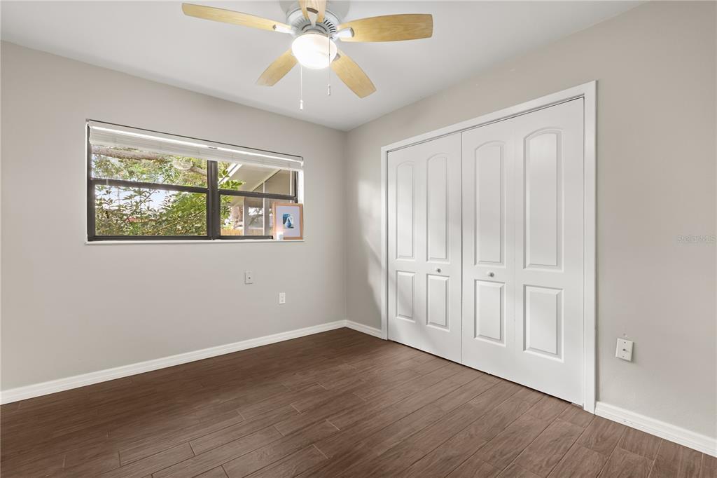 660 Java Road Cocoa Beach, FL 32931 - Photo 15 of 31 a view of an empty room with wooden floor and a window