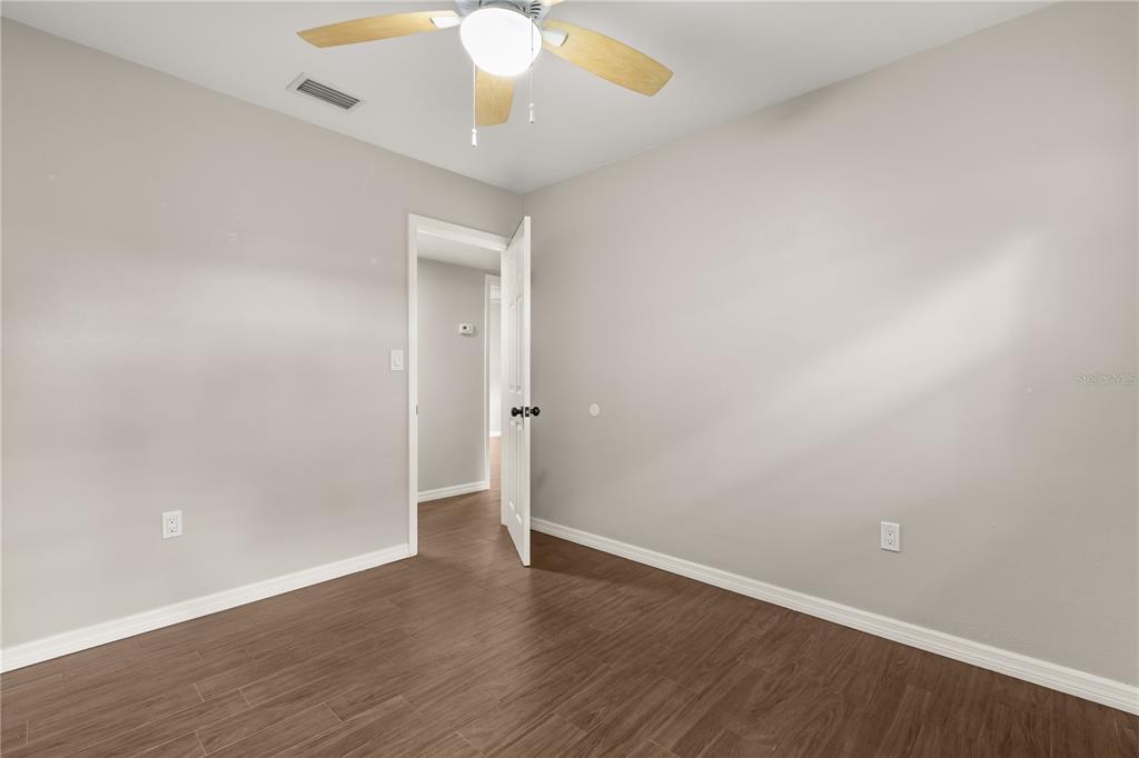 660 Java Road Cocoa Beach, FL 32931 - Photo 16 of 31 a view of an empty room with wooden floor