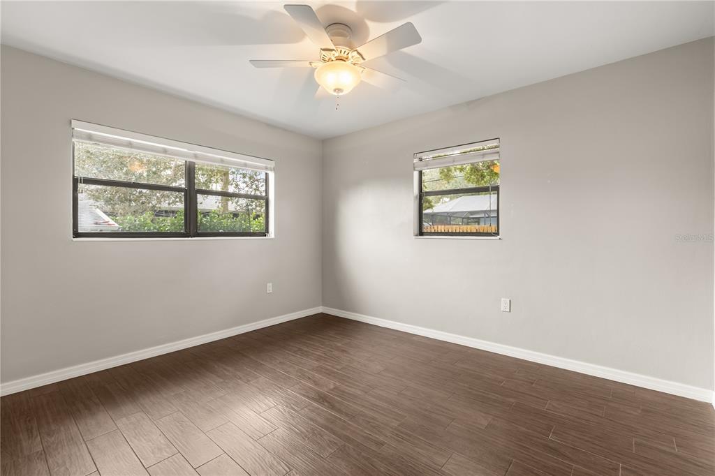 660 Java Road Cocoa Beach, FL 32931 - Photo 18 of 31 a view of an empty room with wooden floor and a window