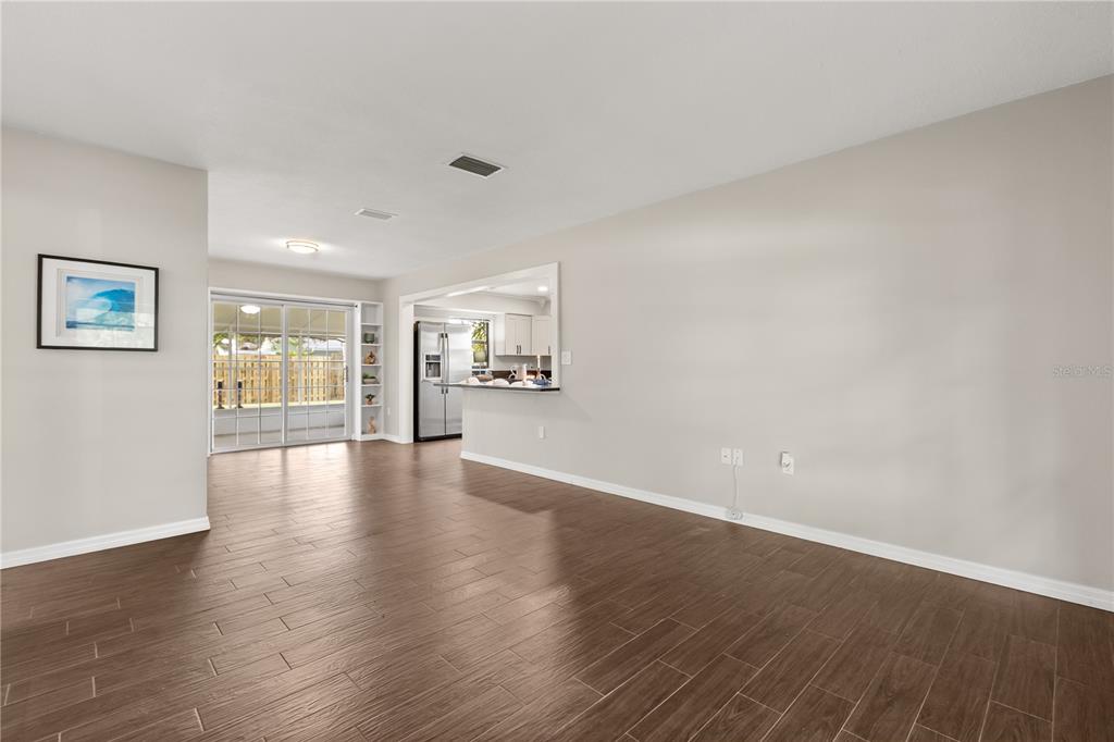 660 Java Road Cocoa Beach, FL 32931 - Photo 5 of 31 a view of an empty room with wooden floor and a window