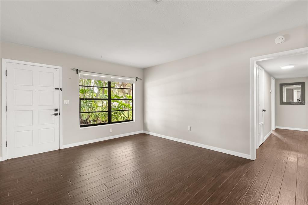 660 Java Road Cocoa Beach, FL 32931 - Photo 6 of 31 an empty room with wooden floor and windows