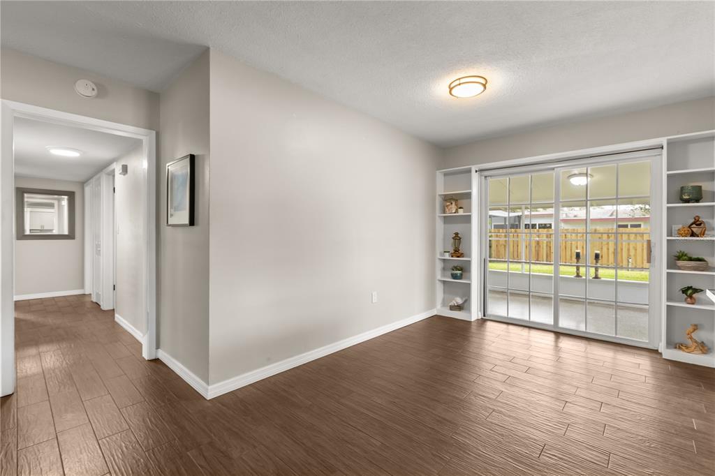 660 Java Road Cocoa Beach, FL 32931 - Photo 7 of 31 wooden floor in an empty room with a window