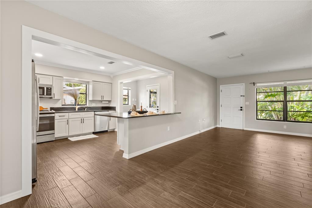 660 Java Road Cocoa Beach, FL 32931 - Photo 9 of 31 a view of a kitchen with a sink cabinets and wooden floor