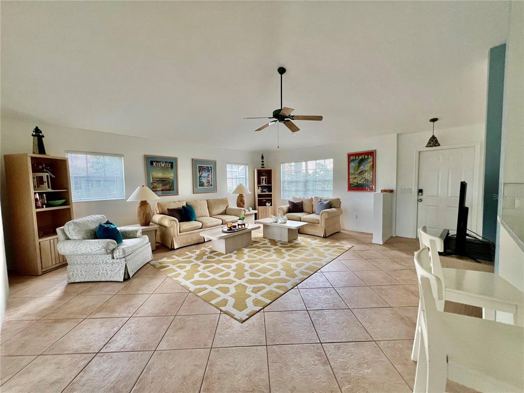 4005 Big Pass Lane Punta Gorda, FL 33955 - Photo 13 of 42 a living room with patio furniture and a view of kitchen
