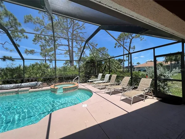 a view of a backyard with sitting area