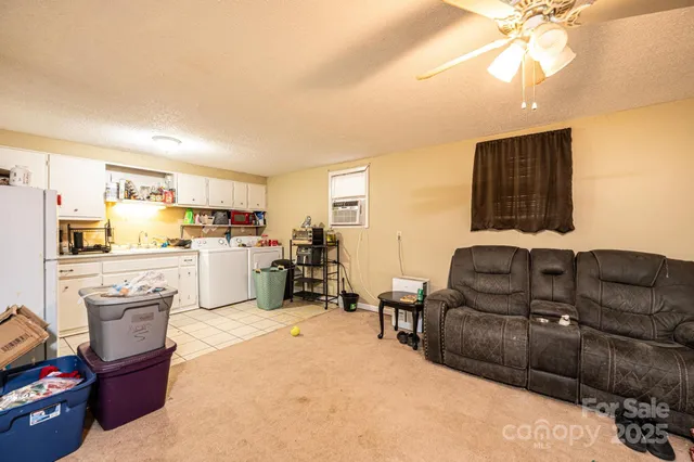 a living room with furniture and kitchen view