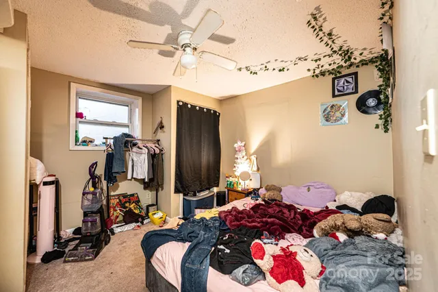 a bedroom with a bed and the view of bathroom