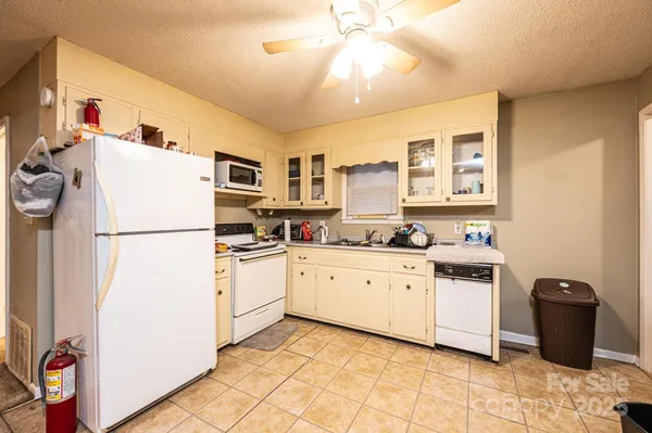 a kitchen with a refrigerator and a sink
